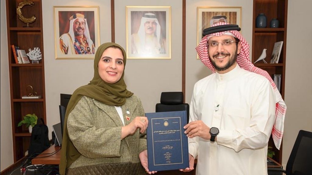 Researcher Latifa Al-Abbasi presents BNET`s Chief Executive Officer a copy of her Master's Thesis